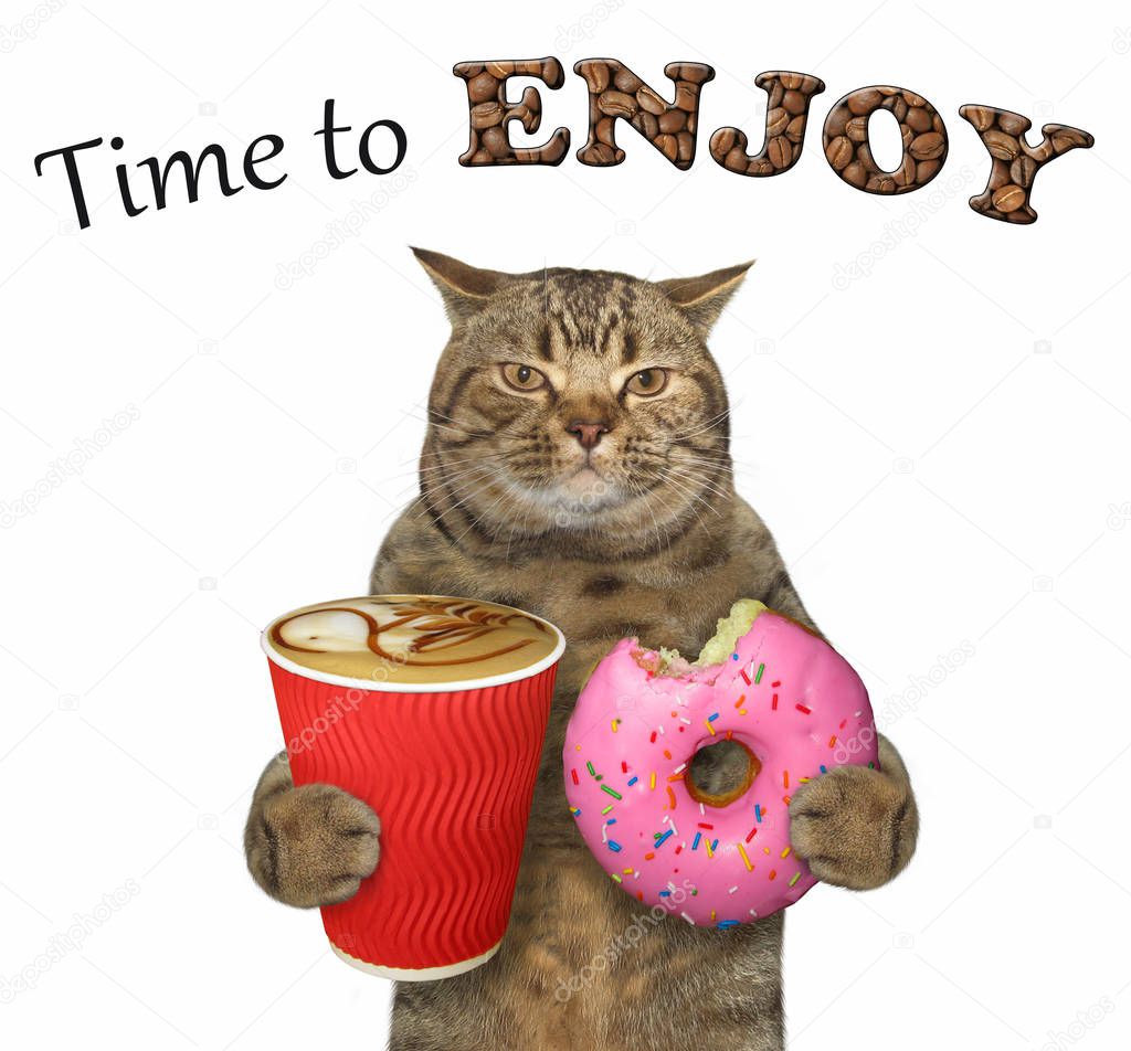 The cat holds a pink bitten doughnut and a cup of coffee. Time to enjoy. White background.