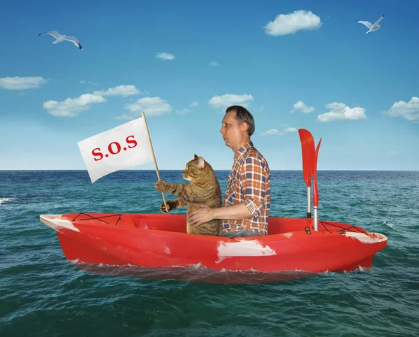 Man with his cat in a red kayak