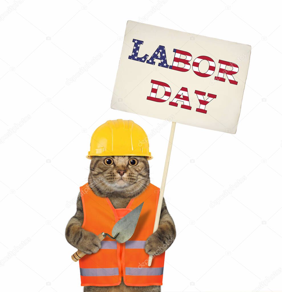 The beige cat worker in a vest and a helmet is holding a trowel and a sign Labor Day. White background. Isolated.