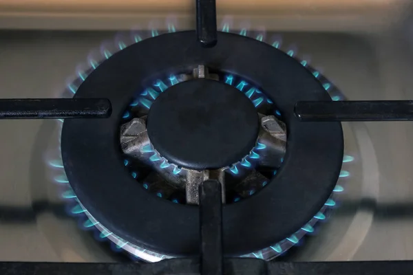 Gas burner flame at gas stove, close-up.