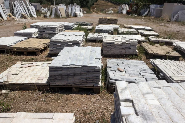 Building material shop.  Decorative building stone, marble and granite lie on the pallet.