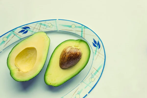 Twee Helften Van Rijpe Avocado Een Plaat Concept Gezonde Voeding — Stockfoto