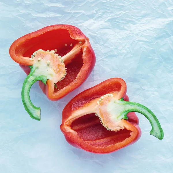 Halves of red sweet pepper on parchment paper. The concept of a healthy diet, vegetarianism, raw food, a source of vitamin C.