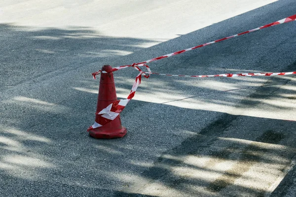Fencing red and white tape, which prohibits movement. Warning, police tape.  Concept- crime scene,  danger.