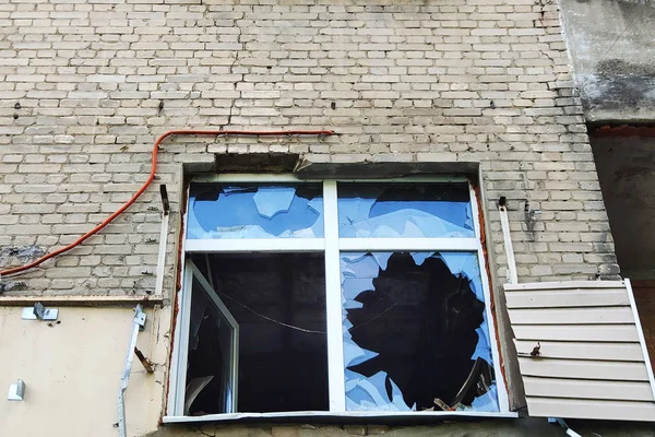 House with broken windows and damaged walls. Concept- war, devastation, disasters, emergencies.