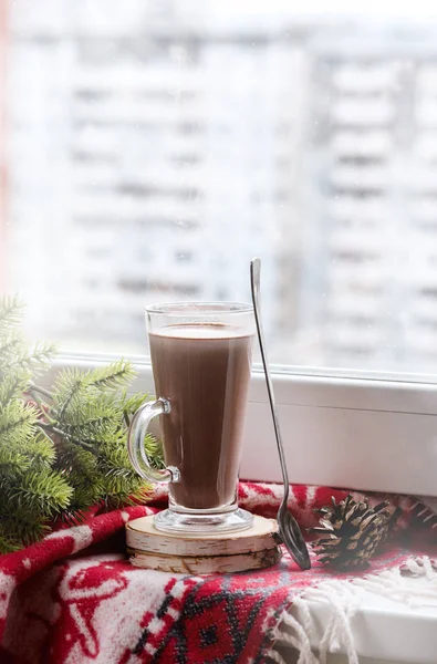 Glass Cup of Tasty with Cocoa Near the Window Woolen Blanket Fir Branches Cones Vertical Christmas Card Concept