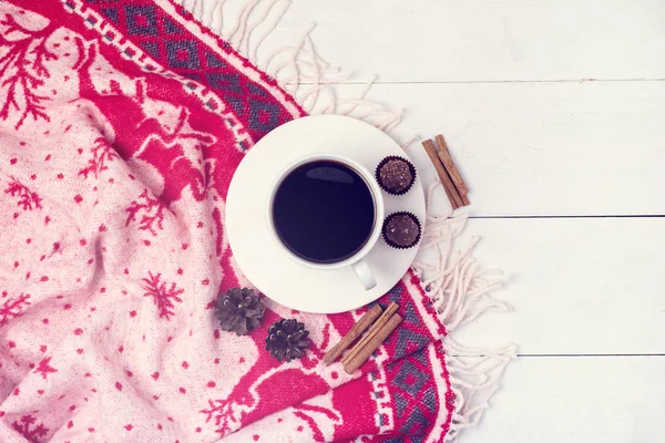 Winter Coffee in a White Cup with Chocolate Candy Christmas Warm Blanket Cozy Christmas Concept Copy Space Flat Lay