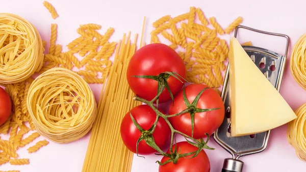 Italian Food Ingredients on Pink Background Variety of Pasta Cheese Tomato Top View Long Italian Food Background