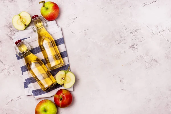 Bottles of Apple Vinegar and Ripe Apples on Light Gray Background Top View Flat Lay Apple Cider