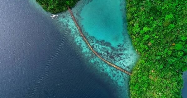 Aerial view of Sugba lagoon. Beautiful landscape with blue sea lagoon and bridge, National Park, Siargao Island, Philippines.