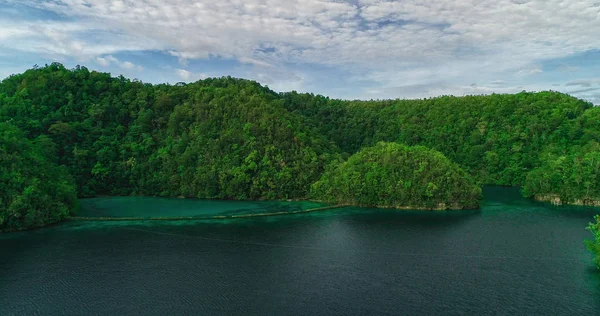 Aerial view of Sugba lagoon. Beautiful landscape with blue sea lagoon, National Park, Siargao Island, Philippines.