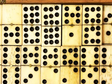Antique ivory handmade dominoes in a wooden box clipart