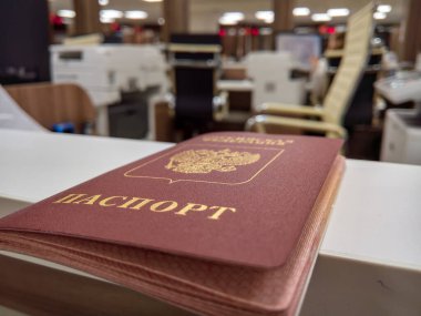 MOSCOW, RUSSIA - FEBRUARY 29, 2020: Obtaining a new Russian passport lying on a shelf in the municipal institution My Documents clipart