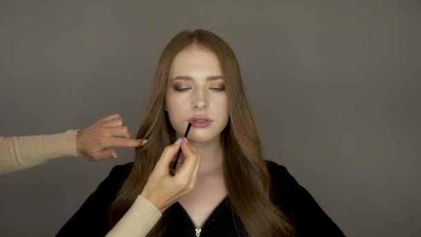 Model meisje voor de camera zet make-up — Stockvideo