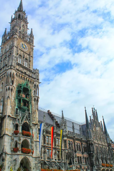 Munich\'s historic town hall on the Marienplatz square, decorated with flags. Germany.