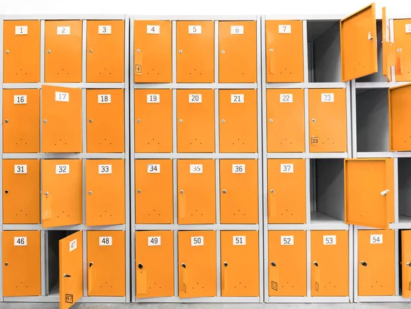 many orange cabinets, safe deposit boxes with keys for storing things in the supermarket and store. Safes for buyers