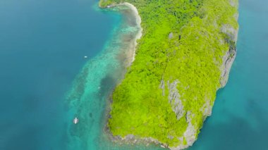 Kristal berrak sularla çevrili tropikal adanın üst görüntüsü. Kumlu sahil şeridi ve El Nido, Palawan 'daki yeşil kayalıklar. Filipinler.