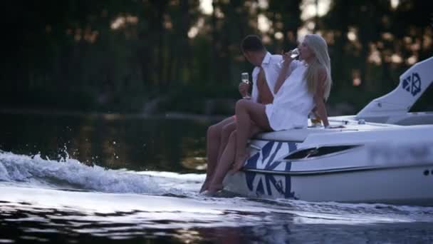 Lovely charming couple relaxing on floating boat. Romantic boating on river — Stock Video