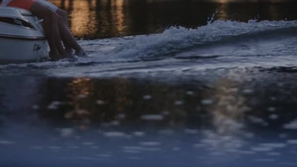 Close up of people legs hang out from yacht. Romantic date on floating boat — Stock Video