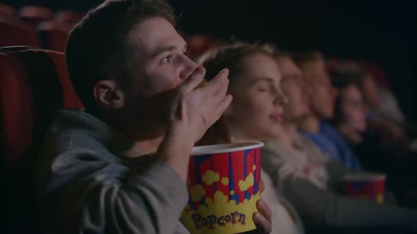 Homem mau a comer pipocas no cinema. Maneiras grosseiras na sala de cinema — Vídeo de Stock