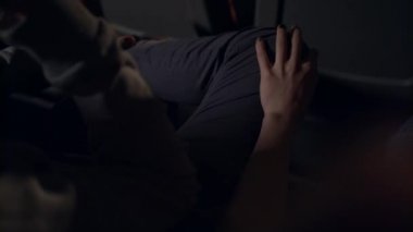 Kadın sinema içinde adamla flört. Kız bacak eliyle okşayarak adam