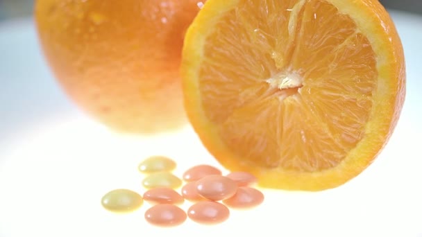 Píldoras vitamínicas con fruta naranja. Suplementos dietéticos. Concepto de salud — Vídeo de stock