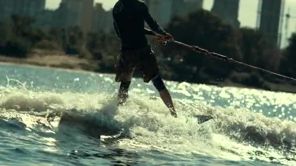 Extreme sportsman riding water. Wake boarding sport. Summer adrenaline — Stock Video