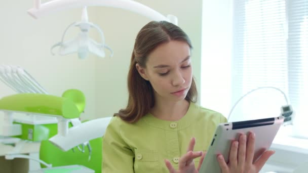 Dentist working on tablet pc in dental office. Healthcare worker using tablet — Stock Video