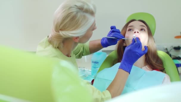 Doctor working with patient in modern dental clinic. Female dentist — Stock Video