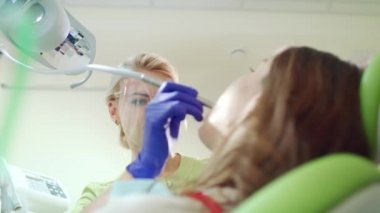 Hasta diş tedavi kadın diş hekimi. Sarışın doktor koruyucu gözlük