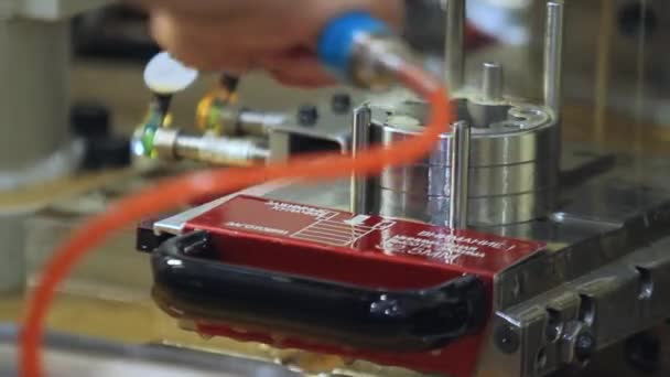 Factory worker washing lubricant from metal parts with stream of water — Stock Video