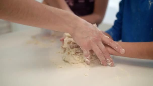 Мати допомагає синові готувати тісто. Жінка навчає дітей готувати торт — стокове відео