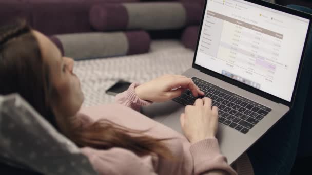 Ділова жінка працює на портативному комп'ютері вдома. Віддалена робота вдома — стокове відео