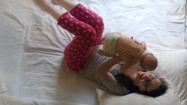 Schöne Frau mit Säugling über dem Kopf. süßes Kind in Mama-Umarmung — Stockvideo
