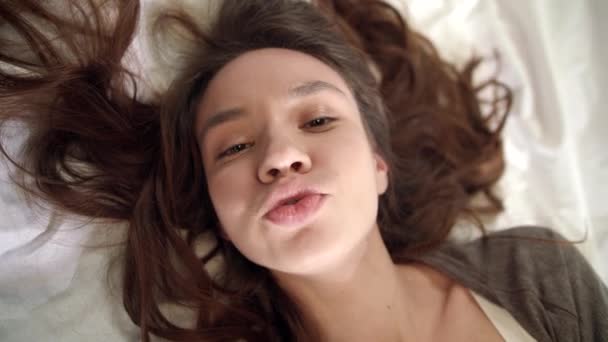 Top view of smiling woman face kissing lips looking at camera. Woman flirting — Stock Video
