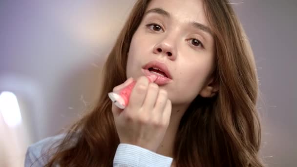 Mujer joven que aplica lápiz labial líquido en los labios. Belleza dama con brillo de lápiz labial — Vídeo de stock