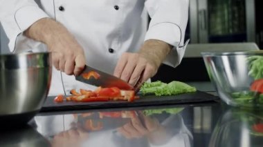 Şef mutfakta sebze pişiriyor. Organik gıda ları kesen yakın eller