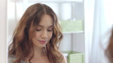 Banyoda krem kullanan gülümseyen kadın. Kozmetik krem süren kadın