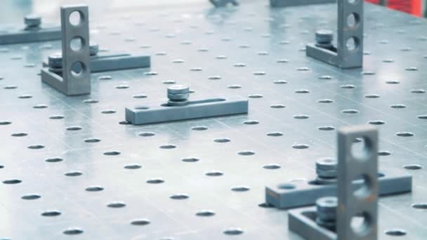 Fasteners on working surface of industrial unit. Metallic plate with holes — Stock Video