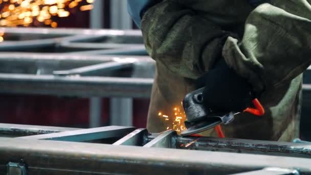 Polishing welding seams with angle grinder at plant. Using industrial instrument — Stock Video