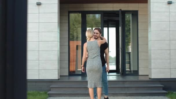 Schönes Paar, das sich in der Nähe von Appartements umarmt. Mann und Frau küssen sich im Freien — Stockvideo