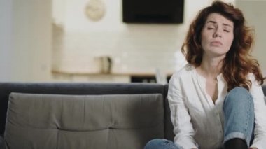 Sıkıcı kadın açık mutfakta TV kanallarını kontrol ediyor. Uykulu kız TV kapatma.