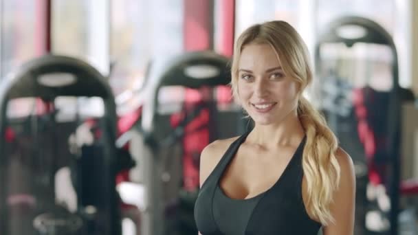 Porträt einer Trainerin mit Daumen-hoch-Geste im Fitnessclub. — Stockvideo