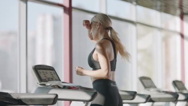 Running kvinna öva på löpband maskin i Fitness gym. — Stockvideo