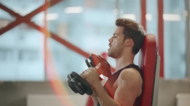 Strong man weightlifter having exercises with dumbbell in sport club. — Stock Video