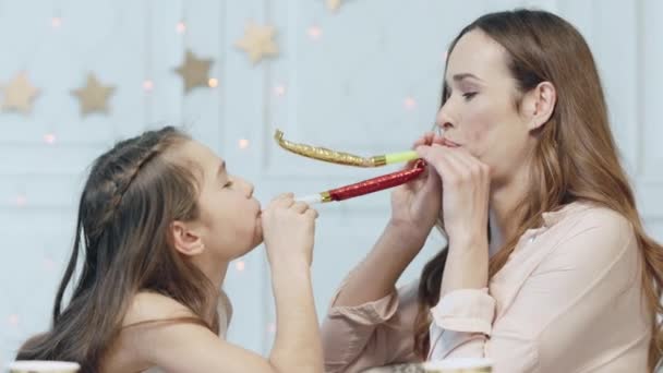Fröhliche Familie macht Spaß mit Geburtstagspfeifen im Luxus-Haus. — Stockvideo