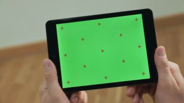 Tablet tutan erkek elleri. Tablet yeşil ekran tablet dokunarak adam kadar yakın