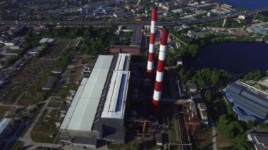 Industrial chimney power plant in modern city. Drone view pipe water power plant