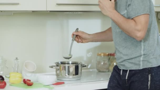 Primer plano hombre feliz cocinar una cena saludable en la cocina moderna . — Vídeo de stock