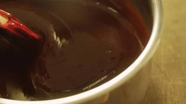 Closeup liquid chocolate making in slow motion. Macro of stirring chocolate